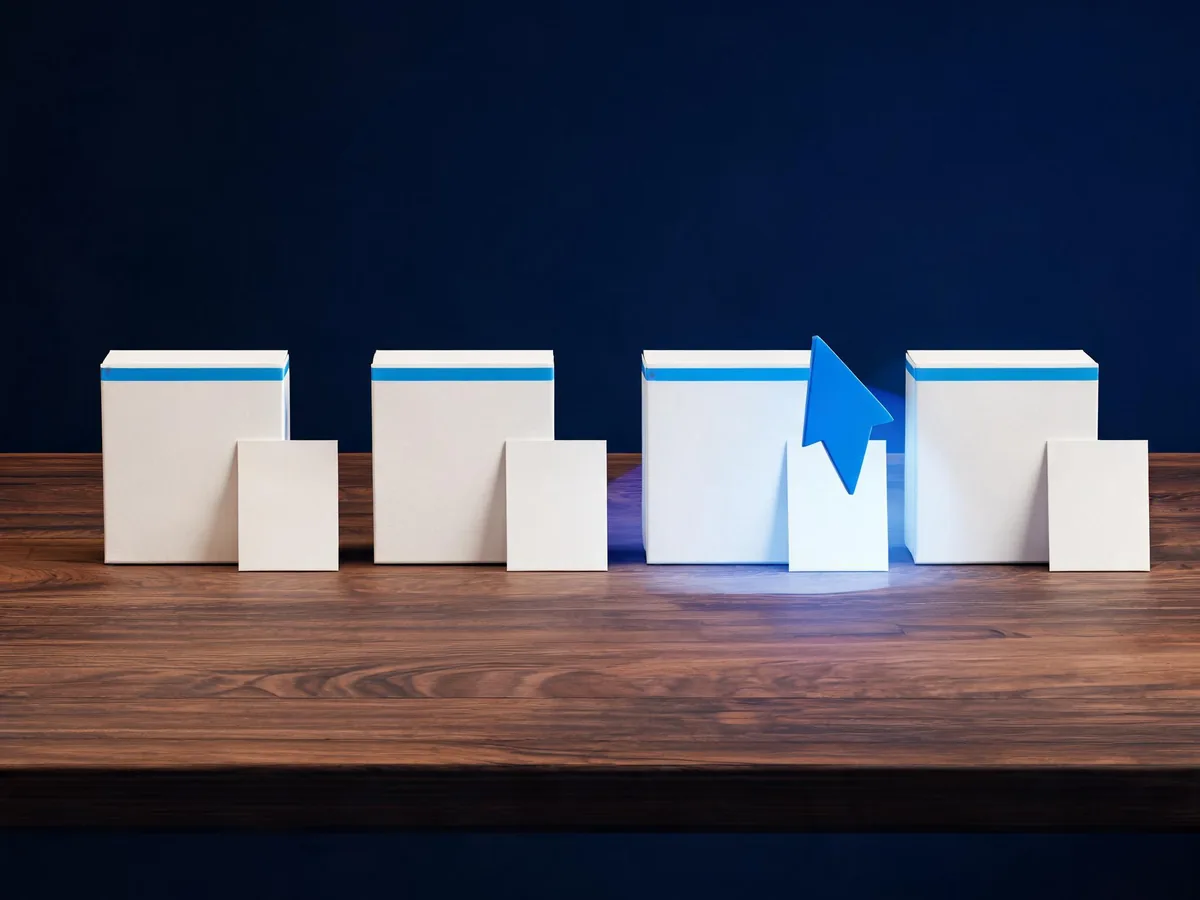 Cited — a neat arrangement of identical product packages with separate address cards, one arrow-shaped paper marker, and a single preferred card on a wooden worktable