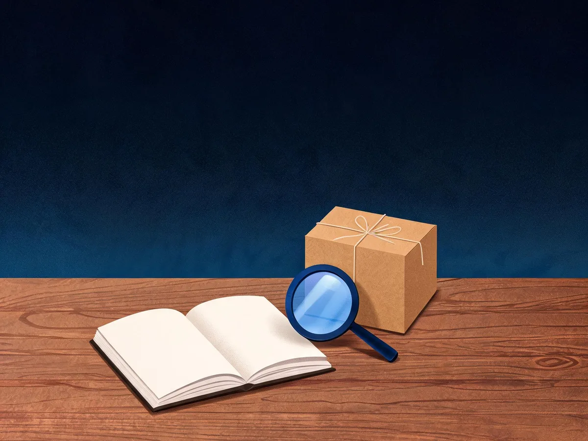 Cited — a tidy notebook, product guide pages, and a magnifying glass beside a shop parcel on a wooden desk