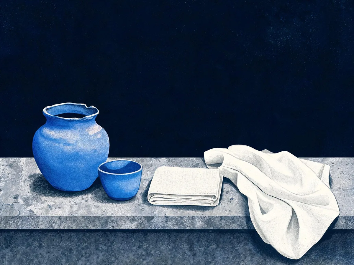 Cited — a flat arrangement of handcrafted ceramic vessels and linen swatches on a stone countertop