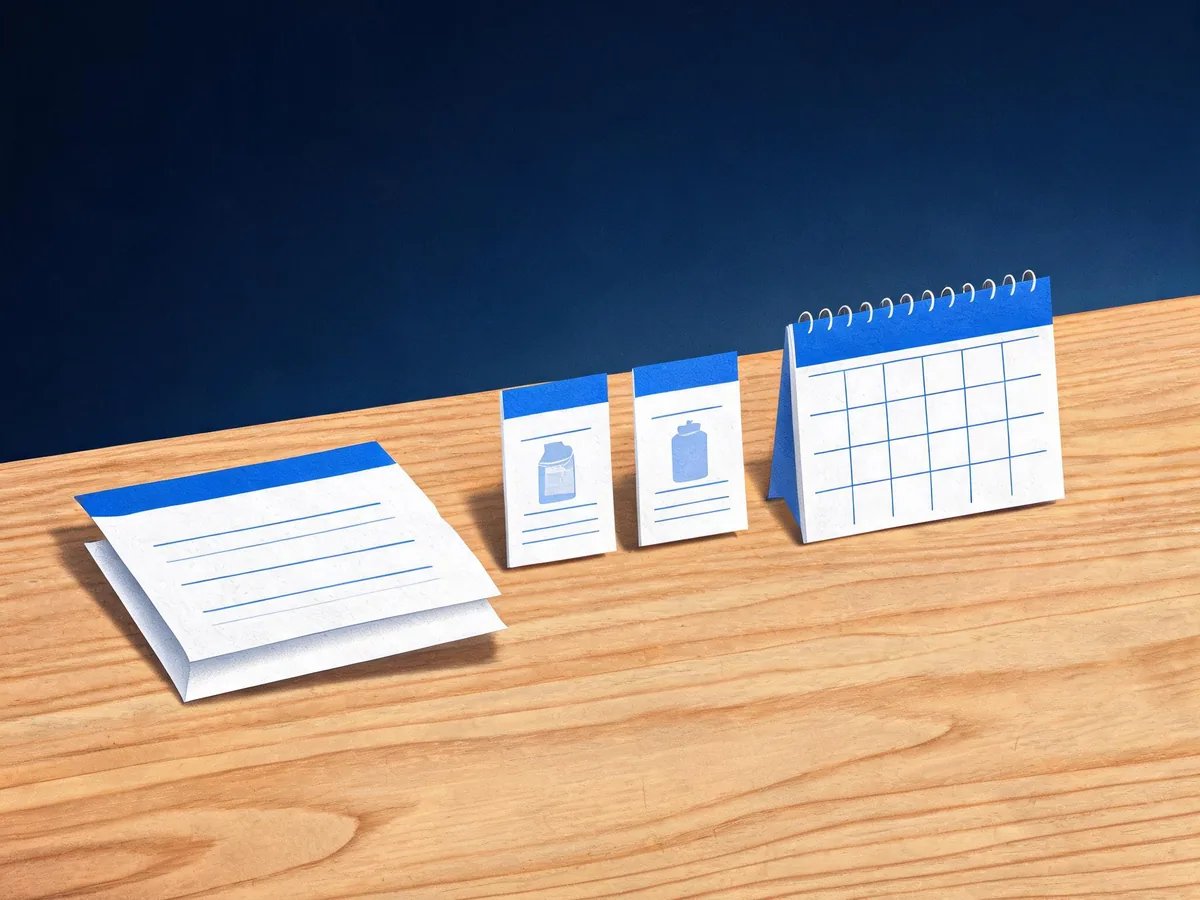 Cited — a paper scorecard beside product comparison cards and a calendar on a wooden desk